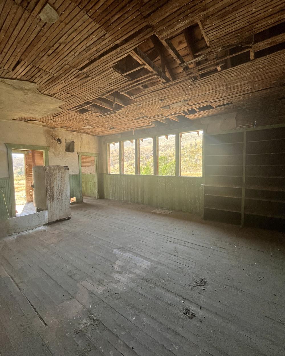 Cabin interior with ceiling and wall finishes removed and the structure left standing
